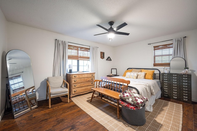 bedroom with baseboards, multiple windows, a ceiling fan, and wood finished floors