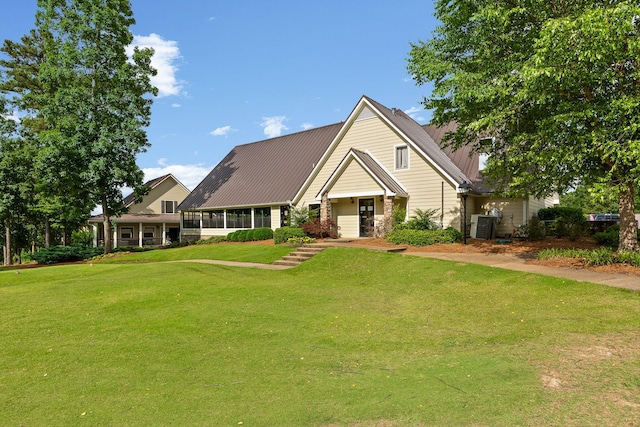 9240 Shay Cv, Ooltewah, TN 37363 - view of front of property featuring a front lawn, metal roof, and cooling unit