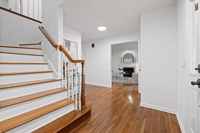 9240 Shay Cv, Ooltewah, TN 37363 - foyer entrance featuring stairs, hardwood / wood-style flooring, baseboards, and a fireplace