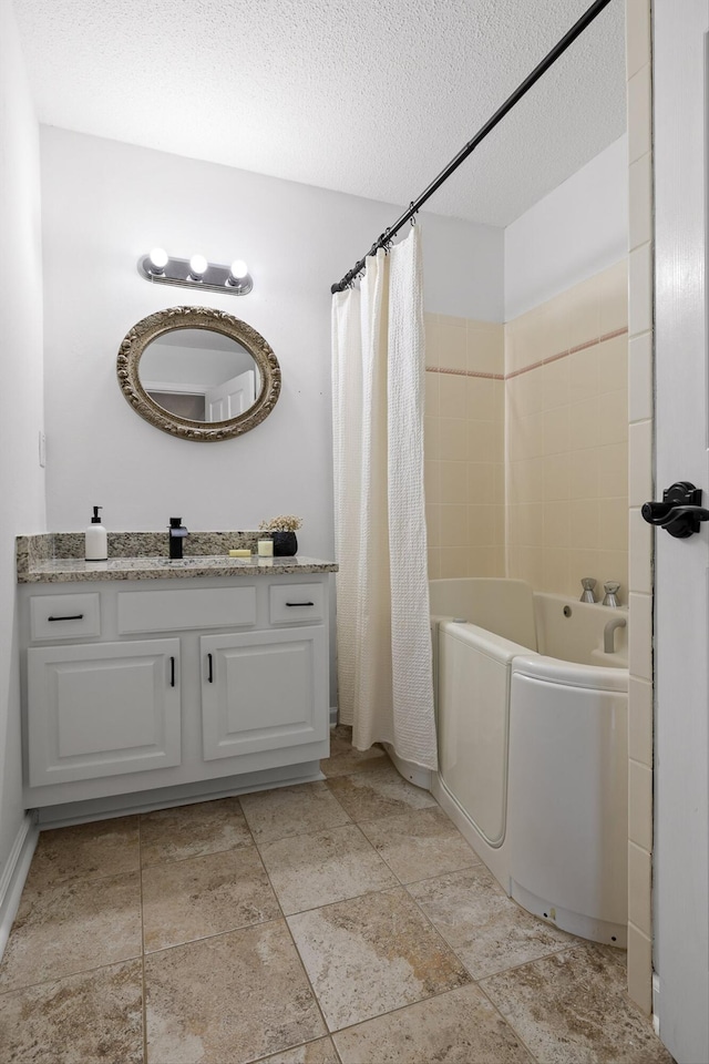 9240 Shay Cv, Ooltewah, TN 37363 - full bath featuring vanity, a textured ceiling, stone finish flooring, and shower / bath combination with curtain