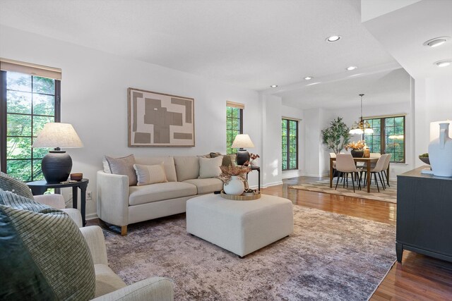 9240 Shay Cv, Ooltewah, TN 37363 - living area featuring wood finished floors, recessed lighting, a chandelier, and baseboards