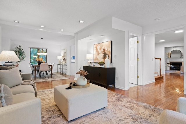 9240 Shay Cv, Ooltewah, TN 37363 - living room with wood finished floors, recessed lighting, baseboards, and a chandelier