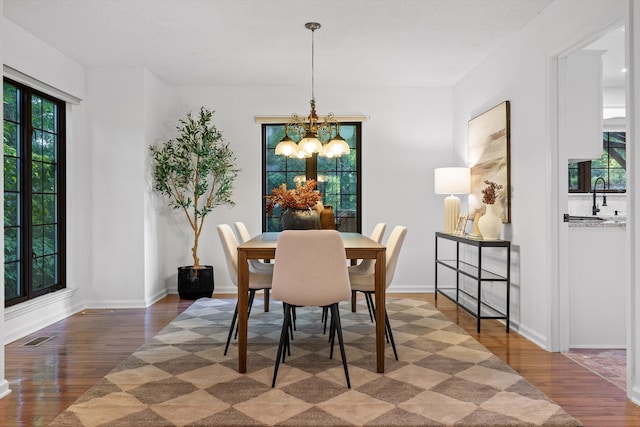 9240 Shay Cv, Ooltewah, TN 37363 - dining space with a chandelier, wood finished floors, and baseboards