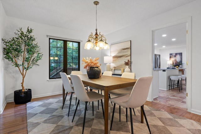 9240 Shay Cv, Ooltewah, TN 37363 - dining area with wood finished floors, a chandelier, recessed lighting, and baseboards