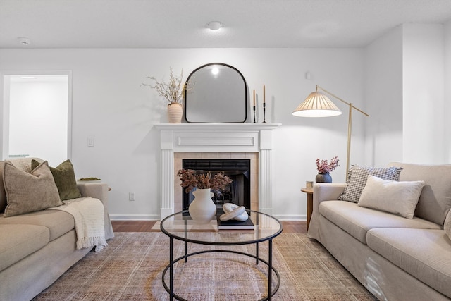 9240 Shay Cv, Ooltewah, TN 37363 - living room featuring wood finished floors, a tile fireplace, and baseboards