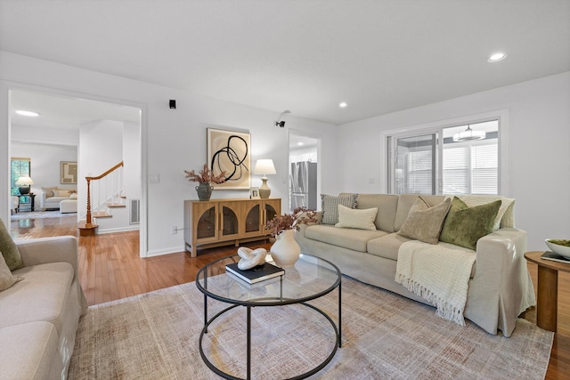 9240 Shay Cv, Ooltewah, TN 37363 - living area with wood finished floors, stairway, recessed lighting, and baseboards