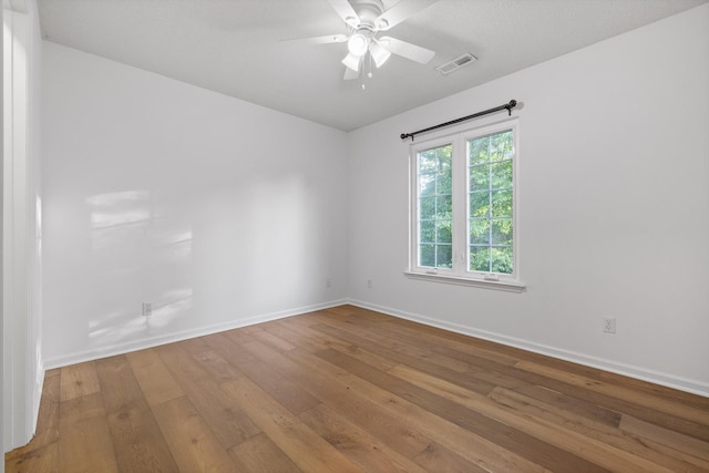 9240 Shay Cv, Ooltewah, TN 37363 - unfurnished room featuring wood-type flooring, ceiling fan, and baseboards