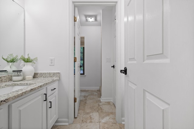 9240 Shay Cv, Ooltewah, TN 37363 - bathroom featuring baseboards, vanity, and stone finish flooring