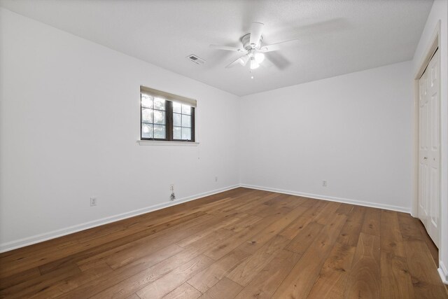 9240 Shay Cv, Ooltewah, TN 37363 - unfurnished bedroom with wood-type flooring, baseboards, a closet, and a ceiling fan