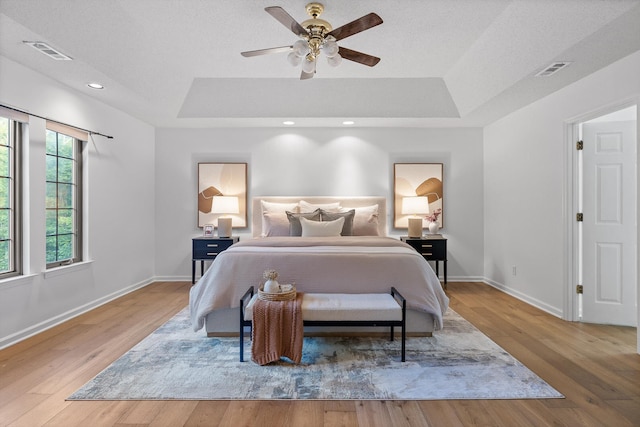 9240 Shay Cv, Ooltewah, TN 37363 - bedroom featuring a tray ceiling, baseboards, wood finished floors, a ceiling fan, and recessed lighting