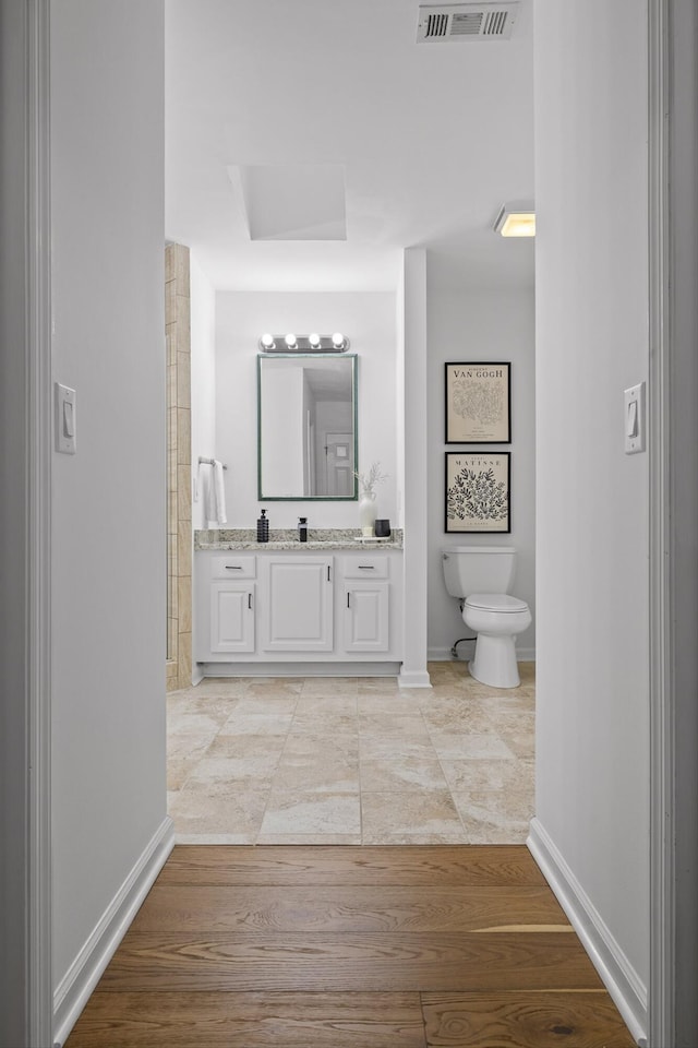 9240 Shay Cv, Ooltewah, TN 37363 - full bathroom with toilet, baseboards, vanity, and wood finished floors