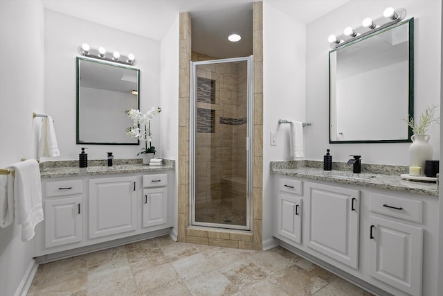 9240 Shay Cv, Ooltewah, TN 37363 - full bath featuring a shower stall, two vanities, and baseboards