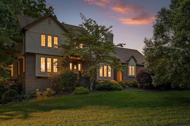 9240 Shay Cv, Ooltewah, TN 37363 - tudor house featuring brick siding, a front lawn, and a chimney