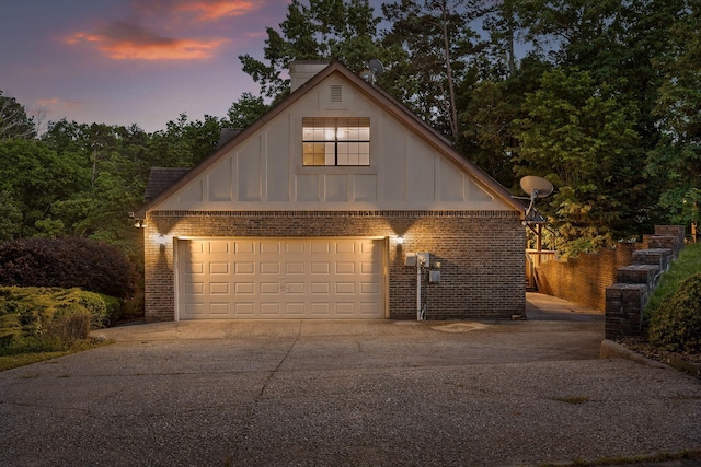 9240 Shay Cv, Ooltewah, TN 37363 - garage at dusk with concrete driveway