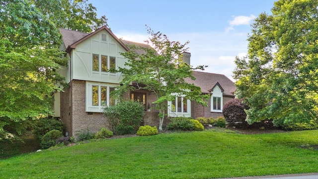 9240 Shay Cv, Ooltewah, TN 37363 - english style home with brick siding, a front yard, and a chimney