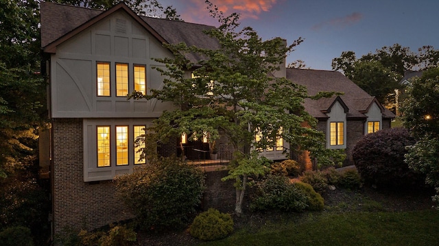 9240 Shay Cv, Ooltewah, TN 37363 - back of house at dusk with brick siding and roof with shingles
