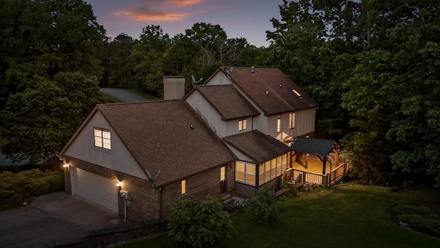 9240 Shay Cv, Ooltewah, TN 37363 - view of front of property featuring a garage, roof with shingles, driveway, a chimney, and a yard