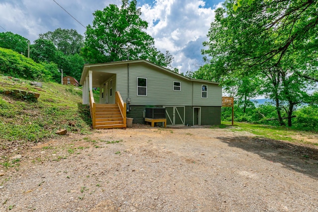 rear view of house featuring central AC and a deck
