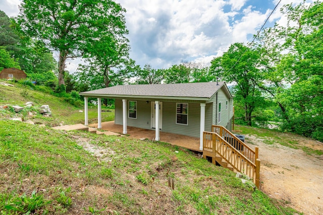 view of front of house featuring a porch and a shingled roof