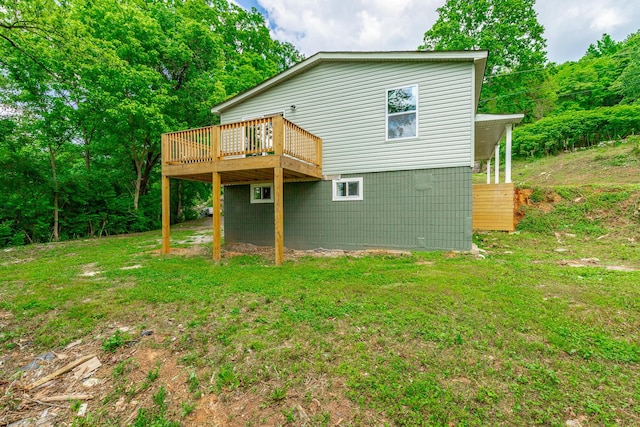 rear view of property featuring a lawn and a wooden deck