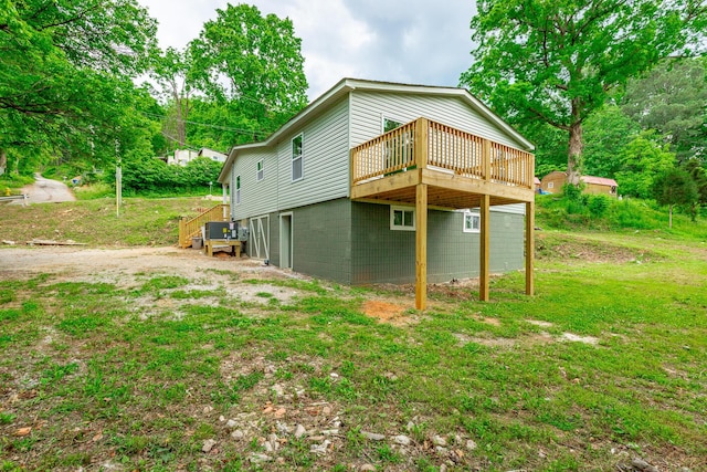 view of home's exterior featuring a yard and a wooden deck