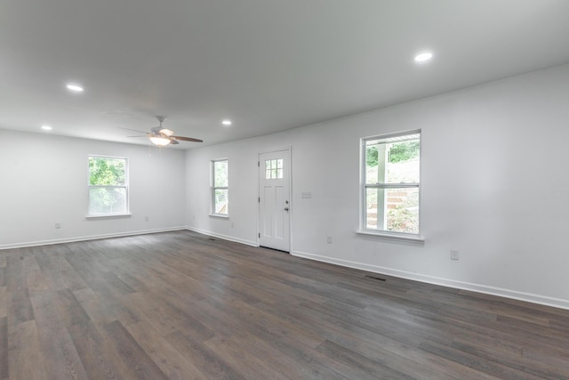 interior space featuring baseboards, a ceiling fan, dark wood-style floors, and recessed lighting