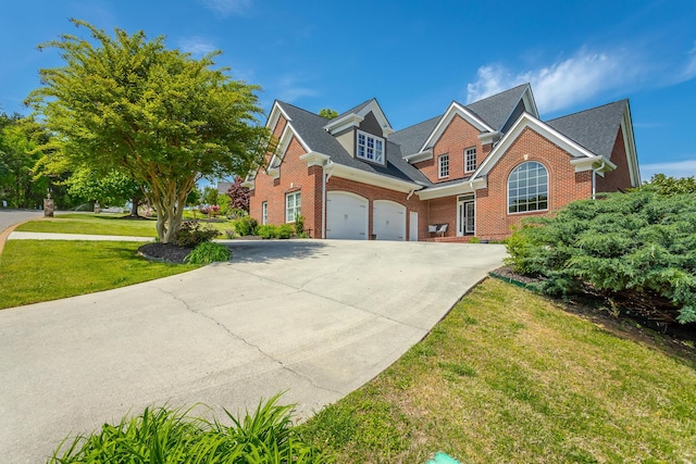 traditional home with a front yard, driveway, and brick siding