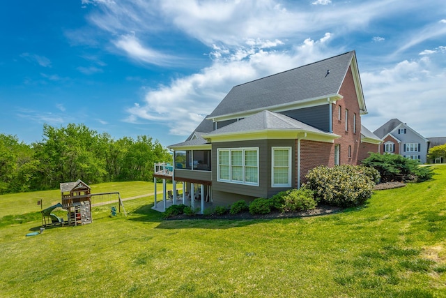 view of home's exterior with roof with shingles and a yard