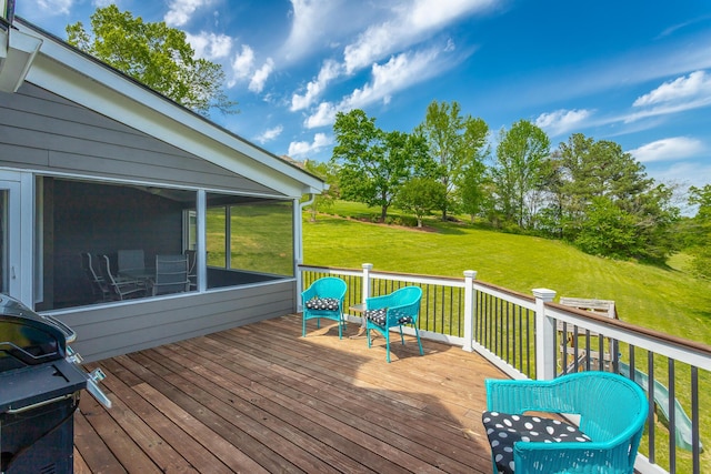 wooden terrace featuring a yard, a sunroom, and grilling area