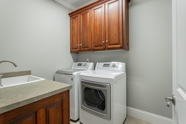 laundry room with separate washer and dryer, a sink, cabinet space, and ornamental molding