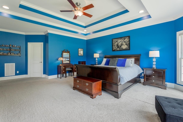 carpeted bedroom featuring a raised ceiling, ornamental molding, and visible vents