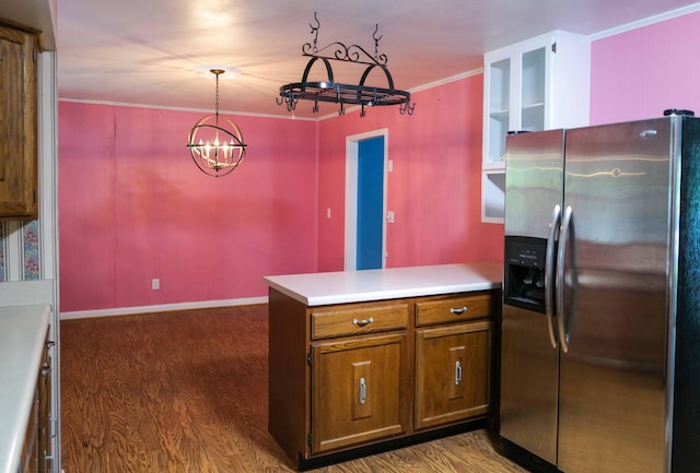 kitchen featuring dark wood-style flooring, stainless steel refrigerator with ice dispenser, a notable chandelier, and a peninsula