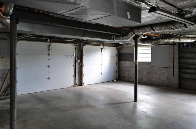 below grade area featuring concrete block wall and a garage