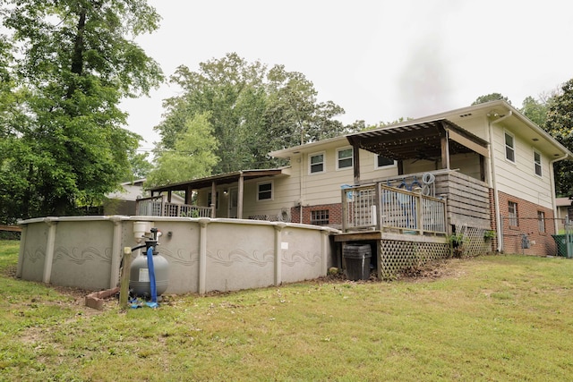 rear view of house with central AC unit, ceiling fan, a wooden deck, and a yard