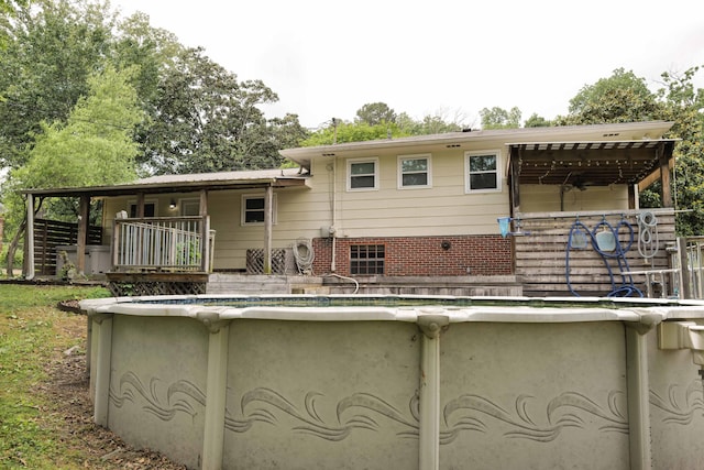 rear view of house with an outdoor pool
