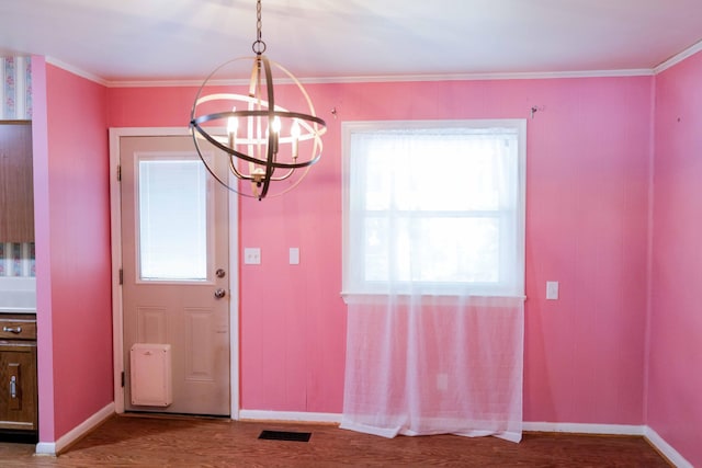 doorway featuring a healthy amount of sunlight, visible vents, wood finished floors, and a notable chandelier