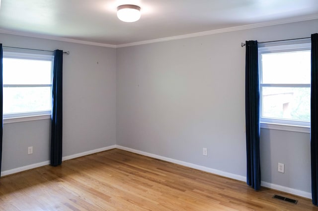 unfurnished room with baseboards, visible vents, ornamental molding, and light wood-style floors
