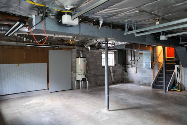 basement featuring stairs and water heater