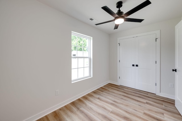 378 Warren St, Rossville, GA 30741 - unfurnished bedroom with a closet, light wood-type flooring, visible vents, baseboards, and ceiling fan
