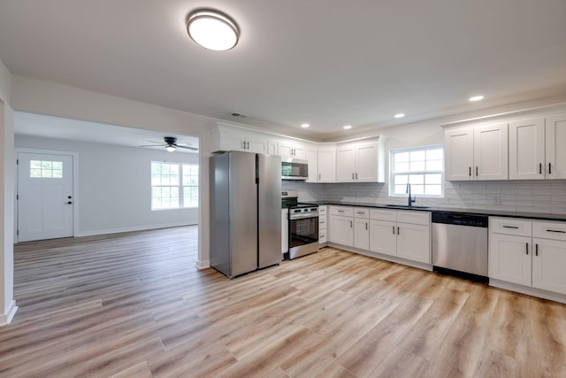 378 Warren St, Rossville, GA 30741 - kitchen featuring a sink, stainless steel appliances, a wealth of natural light, and dark countertops