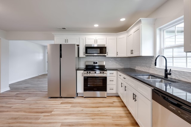378 Warren St, Rossville, GA 30741 - kitchen featuring a sink, dark stone counters, white cabinets, visible vents, and appliances with stainless steel finishes