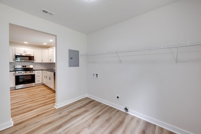 378 Warren St, Rossville, GA 30741 - laundry room featuring electric panel, baseboards, visible vents, and light wood-style floors