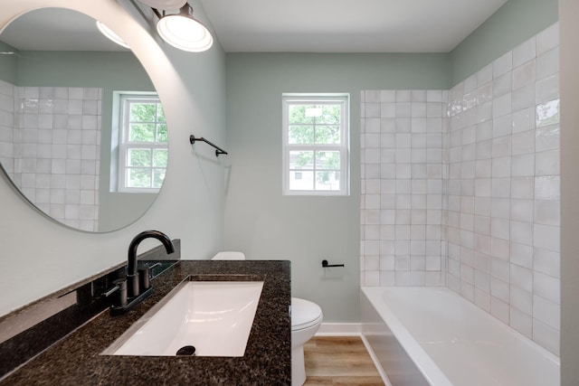 378 Warren St, Rossville, GA 30741 - full bathroom featuring bathing tub / shower combination, toilet, plenty of natural light, and wood finished floors