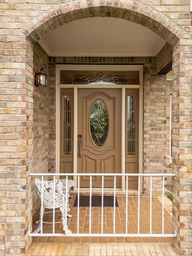 property entrance featuring brick siding