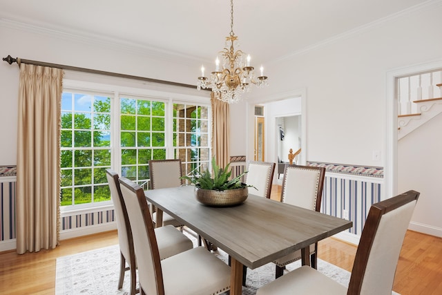 dining area featuring ornamental molding, a chandelier, and plenty of natural light