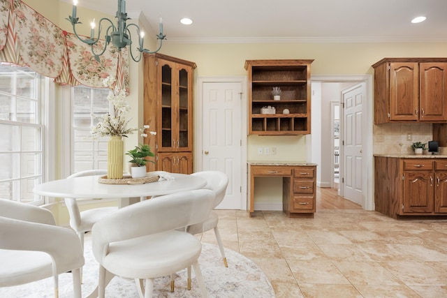dining room featuring an inviting chandelier, ornamental molding, and recessed lighting