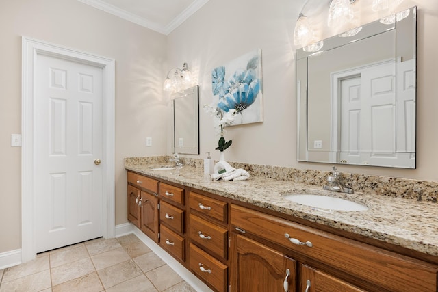 bathroom with baseboards, crown molding, a sink, and double vanity