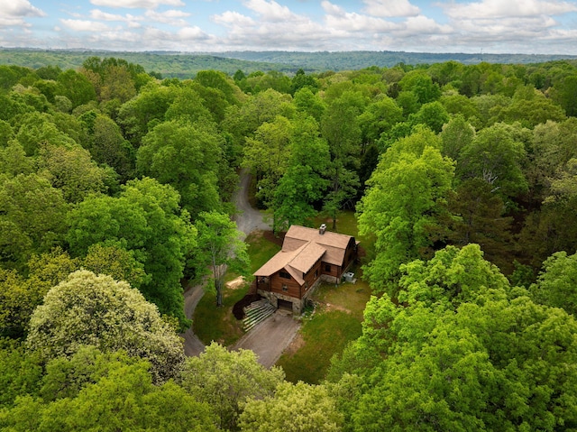birds eye view of property featuring a wooded view