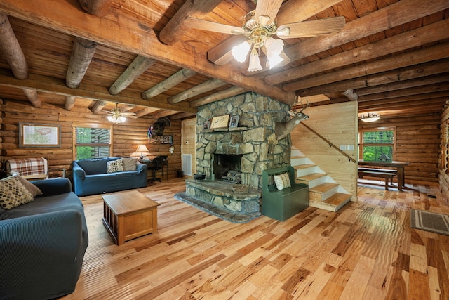 living area with wood ceiling, beamed ceiling, a ceiling fan, and hardwood / wood-style flooring