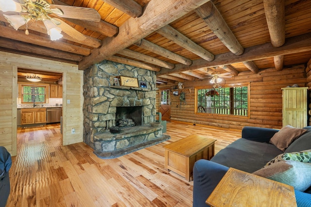 living area featuring a healthy amount of sunlight, wood ceiling, and ceiling fan